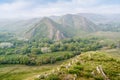 View of the spring mountain landscape through the misty haze