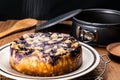 View of sprinkling icing sugar on homemade blueberry and crumble cheesecake Royalty Free Stock Photo