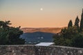 View from the square in front of the church in Mirmande on the setting moon in the morning Royalty Free Stock Photo