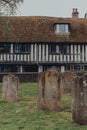 View of St Anthonys timber framed Tudor style building over tombstones on Church Square in Rye, UK