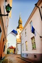 View of St.Mary Church and street with Estonian flags. Tallinn. Royalty Free Stock Photo