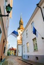 View of St.Mary Church and street with Estonian flags. Tallinn. Royalty Free Stock Photo