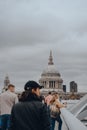 View of St. Pauls Cathedral over the people walking on Millennium Bridge, London, UK, selective focus Royalty Free Stock Photo