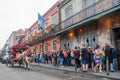 View of St Peter street in New Orleans, with people queuing in front of the Preservation Hall jazz venue and a mule-drawn carriage