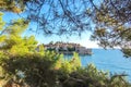 View of St. Stephen's Island in Montenegro through frame of spruce branches Royalty Free Stock Photo