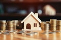 View of stack of coins with house model, housing savings plans, financial concept, real estate mortgage purchase with loan money Royalty Free Stock Photo