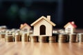 View of stack of coins with house model, housing savings plans, financial concept, real estate mortgage purchase with loan money Royalty Free Stock Photo