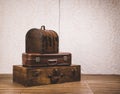 View of a stack of old classic suitcases on a wooden floor. Royalty Free Stock Photo