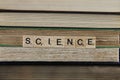 View on stacked old books with word science focus on center