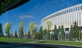 View of stadium and park through the jets of falling water. Fountain `Infinity` in form of huge bowl. Public landscape park Royalty Free Stock Photo