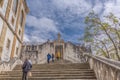 View of stairway of Minerva, gives access to the plaza of the University of Coimbra, people tourists in scene, in Coimbra,