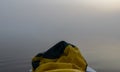 View from stand up paddle to misty reflection in steam water, morning mist on lake