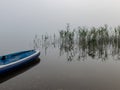 View from stand up paddle to misty reflection in steam water, morning mist on lake