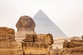 View of Statue of The Great Sphinx of Giza in The Giza Plateau and The Great Pyramid of Giza in the background Royalty Free Stock Photo