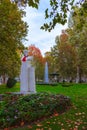 A statue with a red cravat in Zrinjevac park in autumn, Zagreb, Croatia Royalty Free Stock Photo