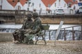 View at the statue of two men seat on bench, artistic personalities on Tomar city