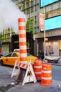 New York City, USA - June 7, 2017: Steam venting from the street in Manhattan by a utility pipe at sunset