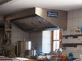 View of steaming pots on a stove and an extractor hood over them in the kitchen Royalty Free Stock Photo