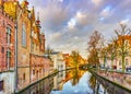 View from Steenhouwersdijk street to typical brick houses along canal, Bruges, Belgium