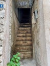 View of steep narrow staircase in old town house, Bonifacio, Corsica. Royalty Free Stock Photo