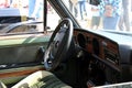 View of the steering wheel and cockpit dashboard in vintage style. Retro car. Royalty Free Stock Photo