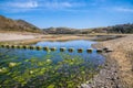 A view of stepping stones stones on the beach at Three Cliffs Bay, Gower Peninsula, Swansea, South Wales Royalty Free Stock Photo