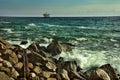 View of the stone beach and stormy sea with a small house Royalty Free Stock Photo