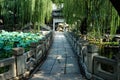 A view on stone Chinese styled bridge on the lake with the Chinese arch at the end