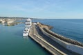 View of stone and concrete breakwaters along the pier, cruise liners and a panorama of the port of Civitavecchia