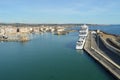 View of stone and concrete breakwaters along the pier, cruise liners and a panorama of the port of Civitavecchia