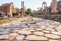 View from the stone floor ground on famous ancient Roman Forum temples, churches, buildings, arches ruins and remains with walking