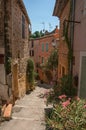 View of stone houses in alley on the slope under blue sky at Les Arcs-sur-Argens.