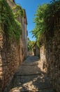 View of stone houses in a narrow alley under blue sky at Les Arcs-sur-Argens Royalty Free Stock Photo