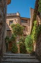 View of stone houses in a narrow alley under blue sky at Les Arcs-sur-Argens