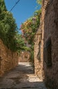View of stone houses in a narrow alley under blue sky at Les Arcs-sur-Argens Royalty Free Stock Photo