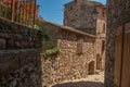 View of stone houses in a narrow alley under blue sky at Les Arcs-sur-Argens Royalty Free Stock Photo