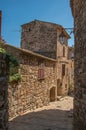 View of stone houses in a narrow alley under blue sky at Les Arcs-sur-Argens Royalty Free Stock Photo