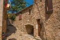 View of stone houses in a narrow alley under blue sky at Les Arcs-sur-Argens Royalty Free Stock Photo