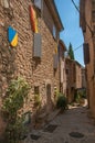 View of stone houses in a narrow alley under blue sky at Les Arcs-sur-Argens Royalty Free Stock Photo