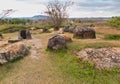 View of stone jars in the Plain of Jars site with Phonsavan town in the background, Laos Dec 2015