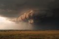 view of storm cloud with lighting and thunder visible, in dramatic tornado-prone landscape