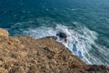 View of the stormy sea from the deserted rocky cape