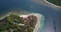 A view of a strait between 2 islands with white sand beaches