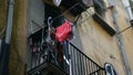 View from street at balcony of lonely person's apartment, ruthless life decline