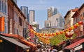 A view of a street in Chinatown district with colorful old buildings and red and yellows lanterns decorations. Royalty Free Stock Photo