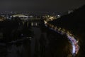 View of street lighting on bridges on the Vltava river in the city of Prague at night and lights from passing cars Royalty Free Stock Photo