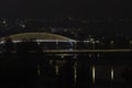 View of street lighting on bridges on the Vltava river in the city of Prague at night and lights from passing cars Royalty Free Stock Photo
