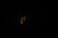 View from the street of a lonely lighten window with one light at