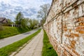 View of the street from the long old brick wall Royalty Free Stock Photo