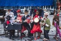 View of street puppet show theatre, with puppeteer puppet master pulling the strings over marionette dolls Royalty Free Stock Photo